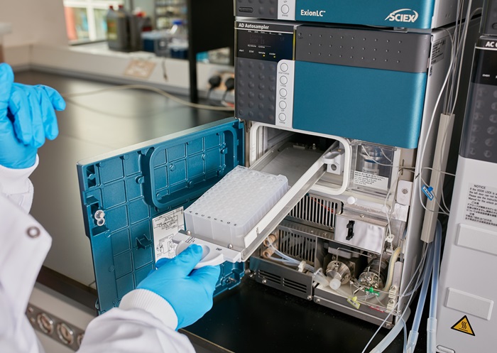 Gloved hands working a machine